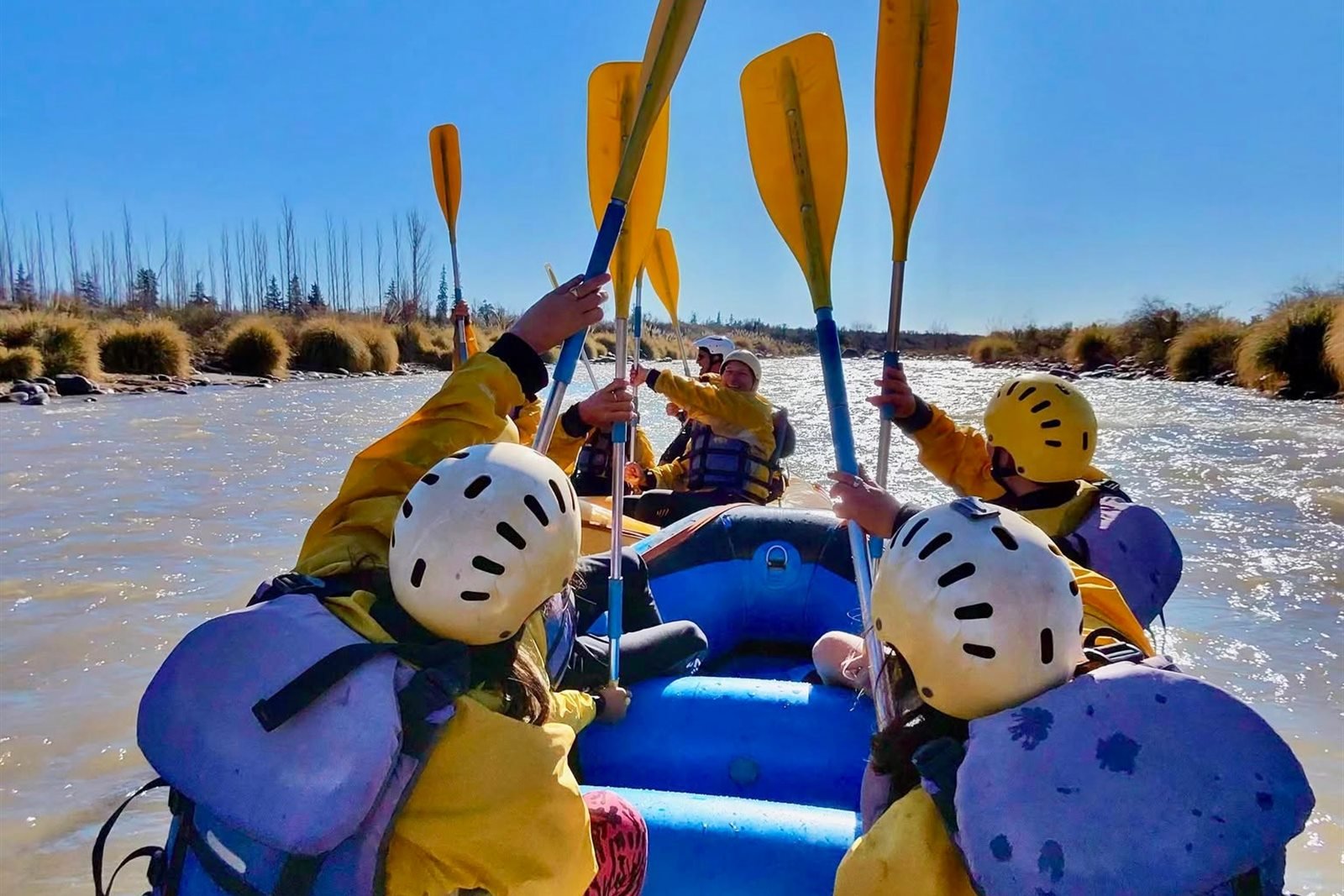 Grupo haciendo rafting en el río de montaña